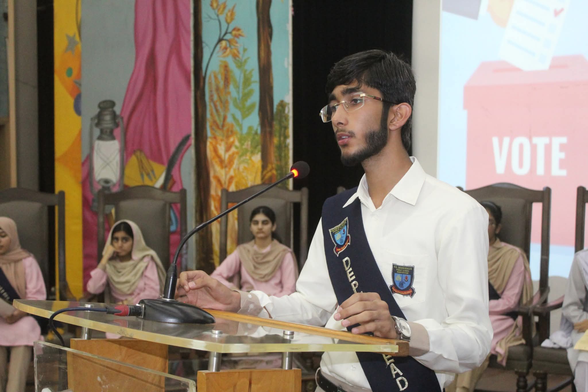 Muhammad Fasih Ur Rehman addressing the assembly at his school